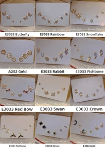 Detailed set of sterling silver needle earrings with cubic zirconia and pearl embellishments
