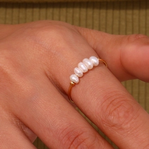 Close-up of 18K gold-plated stainless steel ring with five small freshwater pearls