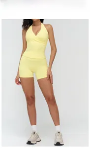 Detail of goose yellow high-waist sports shorts and halter V-neck yoga tank top set