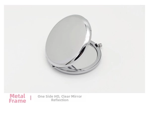 Detail view of a portable round metal makeup mirror with silver frame and HD reflection