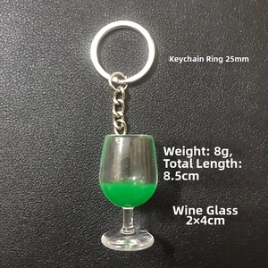 Detail view of resin wine glass keychain dimensions with metal ring on black leather background