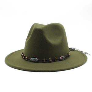 Detailed close-up of olive green wool fedora with flat brim and ethnic beaded trim