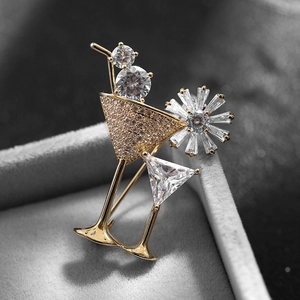 Luxurious cocktail glass brooch with sparkling rhinestones on golden metal base