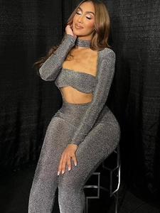 Sparkly silver sequin two-piece set featuring long sleeve crop top and high waist pants