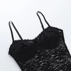 Detailed view of black lace top with delicate straps and intricate floral textures