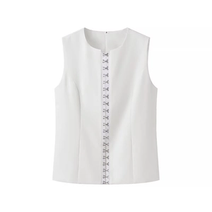 Close-up of white sleeveless vest with metal hook-and-eye closures and size S tag