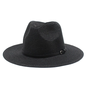 Detailed view of black woven straw fedora with flat wide brim and silver buckle detail