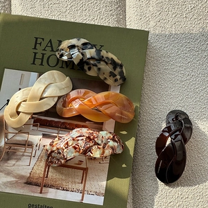 French vintage twist hair clips in various tortoise and cream colors on a magazine