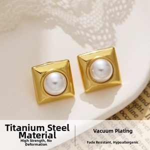 Detailed macro shot of vintage square gold titanium steel earrings with white pearls
