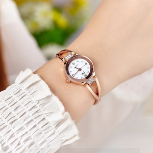 Elegant rose gold women's bracelet watch with round white dial and crystal accents