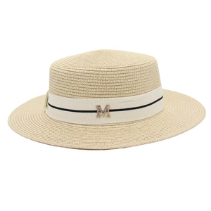Detail of beige woven straw boater hat with white ribbon and rhinestone gold letter M