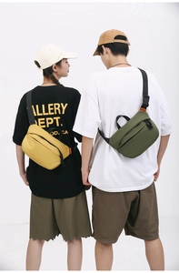 Detailed back view of yellow and olive green nylon crossbody bags with adjustable straps