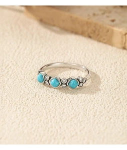 Macro view of S925 sterling silver ring with turquoise stones and shimmering zircon stones
