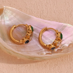 Detail of 18K gold-plated huggie earrings with green, clear, and blue round crystals