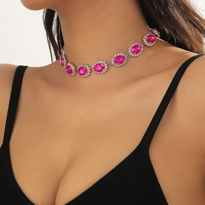 Detail of multi-layered choker featuring magenta oval crystal and white rhinestones