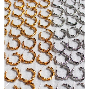 Golden and silver C-shaped hoop earrings with geometric block charms on a white background
