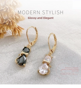 Macro detail of asymmetric cat earrings with black and white teardrop zirconia stones