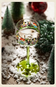 Detailed macro view of hand-painted traditional figures on green stem glass cup