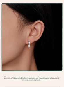 Close-up of S925 silver U-shape earrings with five inset round white moissanite stones