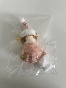 Close-up of pink Christmas angel doll ornament with plush skirt and golden wings
