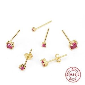 Detail view of gold-plated S925 sterling silver studs with faceted red zircon stones