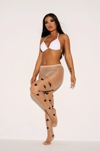 Detail of sheer skin-tone tights featuring black playing card suit prints on the leg