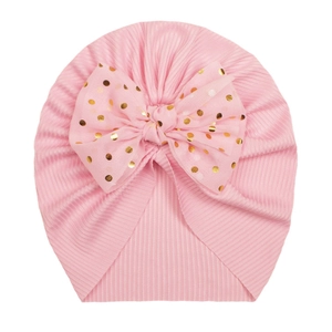 Pink ribbed baby turban hat with golden polka dots bow decoration for infants