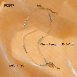 Detail of beaded titanium steel necklace with sunflower pendant and blue gemstone
