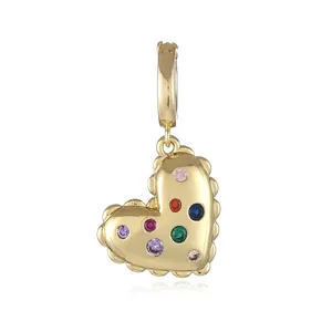 Macro detail of 18k gold-plated heart pendant with multi-colored cubic zirconia stones