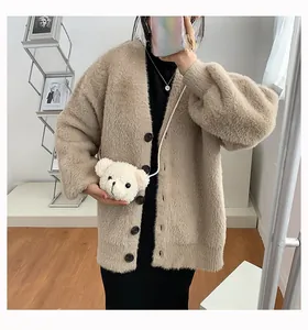 Cute white plush bear head crossbody bag worn over a fuzzy brown oversized cardigan