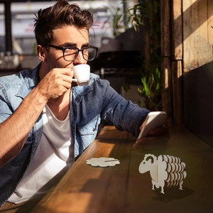 Creative wooden sheep coaster set on coffee shop table with natural light and wood texture