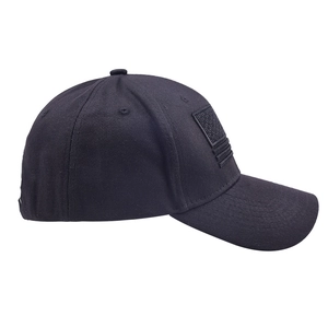 Close-up of a black baseball cap featuring a detailed American flag patch on the side