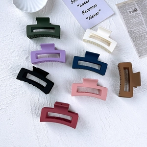 Flat lay of eight colorful matte square hair claws with elegant frosted finish texture