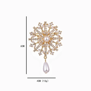 Elegant gold snowflake brooch with pearls and crystals measuring 6cm by 4cm for women