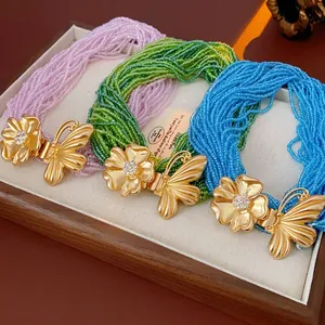Multi-strand beaded necklaces with butterfly floral clasps in pink, green, and blue sets