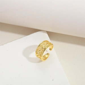 Detailed view of the woven texture on a gold adjustable croissant-style open ring