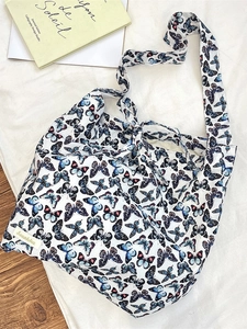 Minimalist white canvas underarm bag with blue butterfly prints for daily commute
