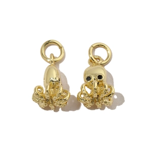 Detailed view of octopus pendant charms with gold finish and black crystal eyes