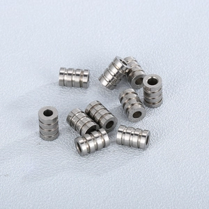 Close-up of cylindrical stainless steel grooved beads for DIY jewelry making