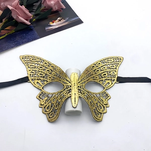 Detailed texture of golden lace butterfly mask with elegant black silk ribbons for parties