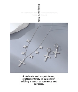 Macro detail of 925 sterling silver cross necklace and star charms with cubic zirconia