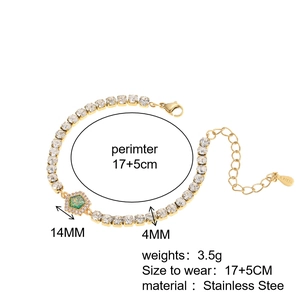 Detail of adjustable golden stainless steel bracelet with green stone pendant and crystal pave
