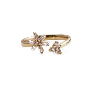 Détail d'une bague dorée avec fleur étoilée en zircons sertis et cristaux fins