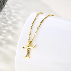 Detail of 18K gold letter T pendant with clear zircons on an O-chain necklace