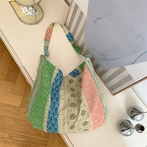 Close-up of floral patchwork canvas tote bag showing colorful plant patterns and fabric texture
