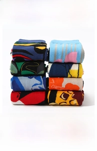 Detail of multi-color cotton socks featuring reinforced ribbed cuffs and geometric patterns