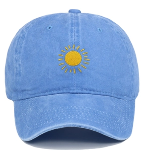 Close-up of sun embroidery on a washed light blue vintage-style cotton baseball cap