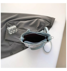 Top view of the interior compartment and lining of this embroidered bucket handbag