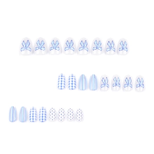 Blue and white checkered press-on nails with bow designs and polka dot patterns
