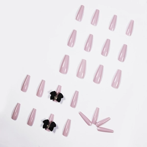 Glossy pink long coffin press-on nails set featuring 3D black ribbon bow accents